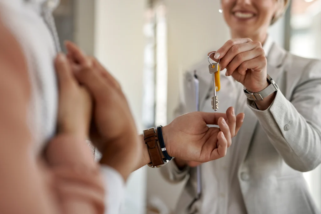 close-up-of-a-couple-receiving-keys-of-their-new-apartment-from-real-estate-agent