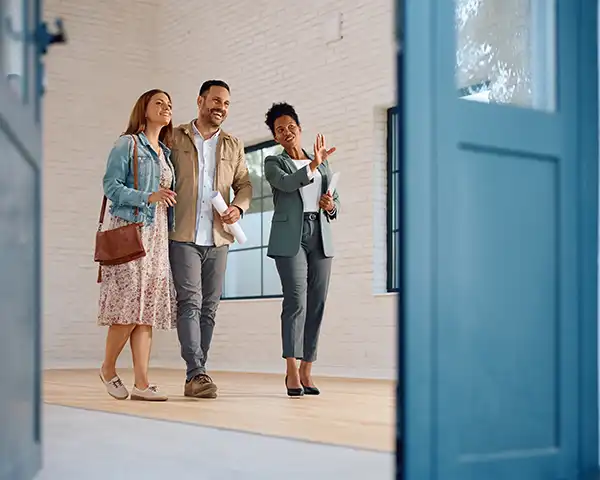 a couple tours a home with a realtor