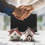 Two hands shaking between real estate developer and property management