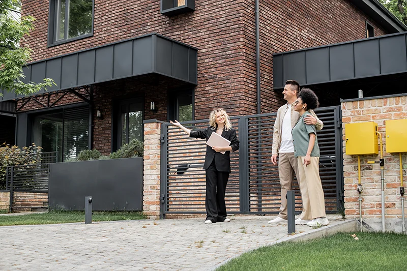 property manager pointing with hand while showing new cottage