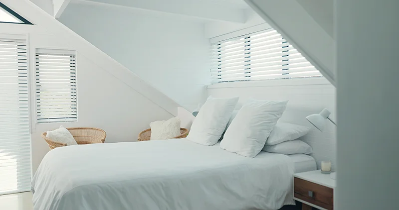 Bed, home and hospitality with white pillow, blanket and duvet for  a rental