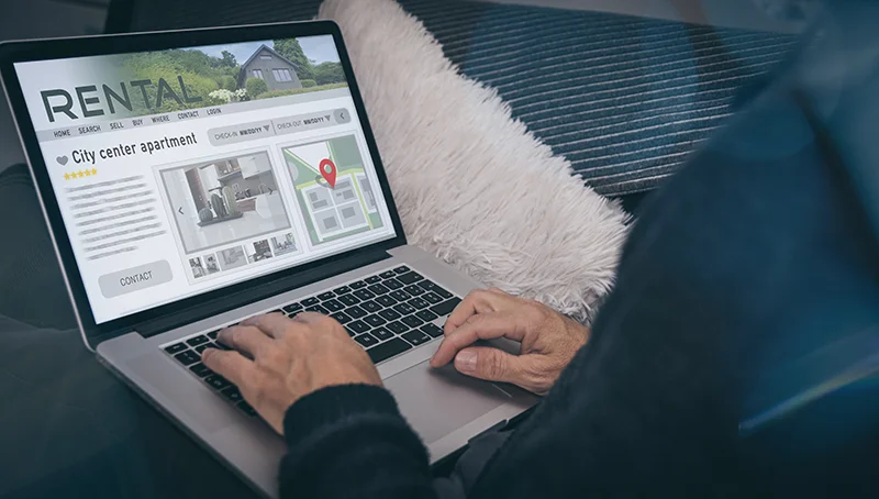 Man reading rental home ads online.