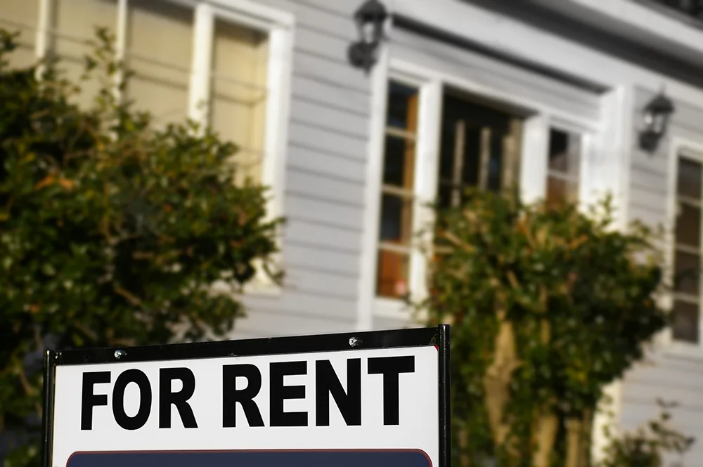 For Rent sign posted in front of a house
