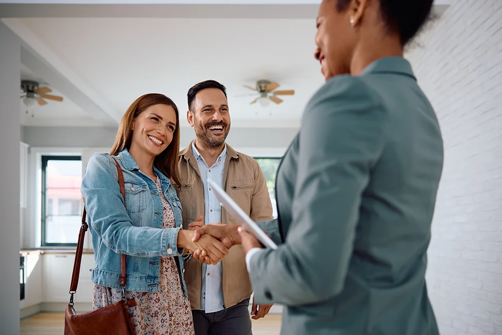 A landlord shaking hands with new tenants