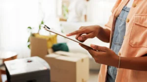 Clipboard, moving and hands of woman in new home