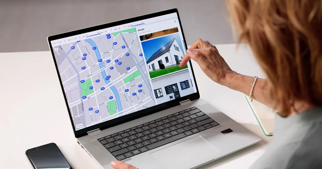 woman using a map on a laptop, searching for a rental property