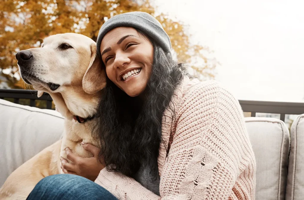 woman and dog on bench for hug